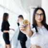 blockchain-investment-concept-business-woman-leader-holding-bitcoin-front-discussing-team-office